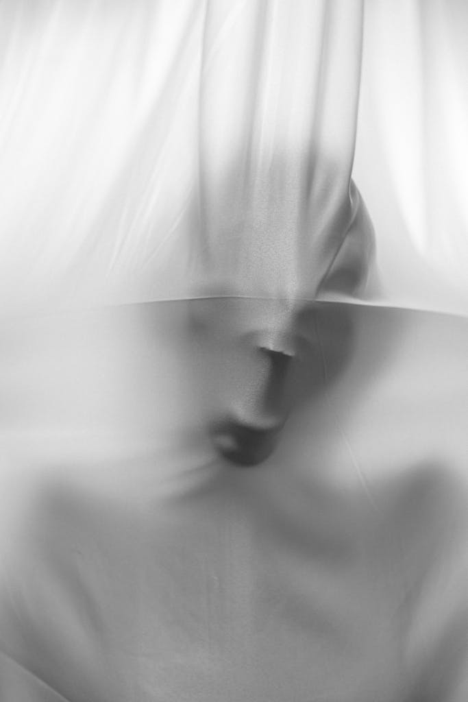 Abstract image of a face pressing against fabric, creating a surreal fear effect.