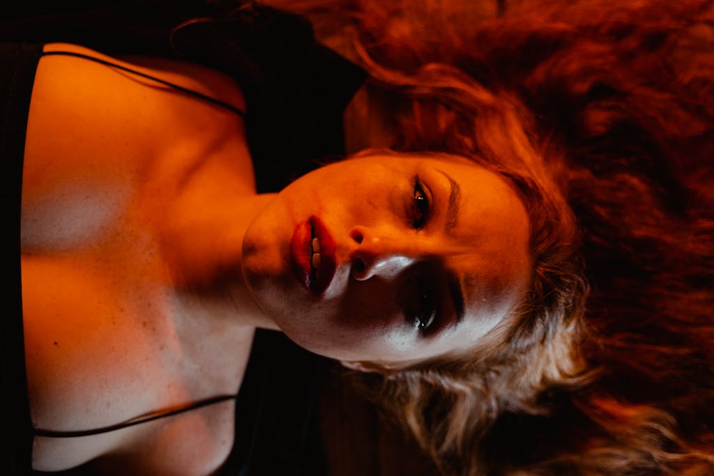 Close-up emotional portrait of a woman lying down, conveying deep feelings and catastrophic thinking.